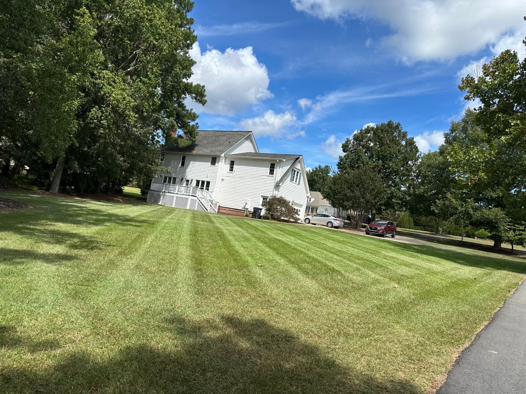 Freshly striped lawn with white two-story home